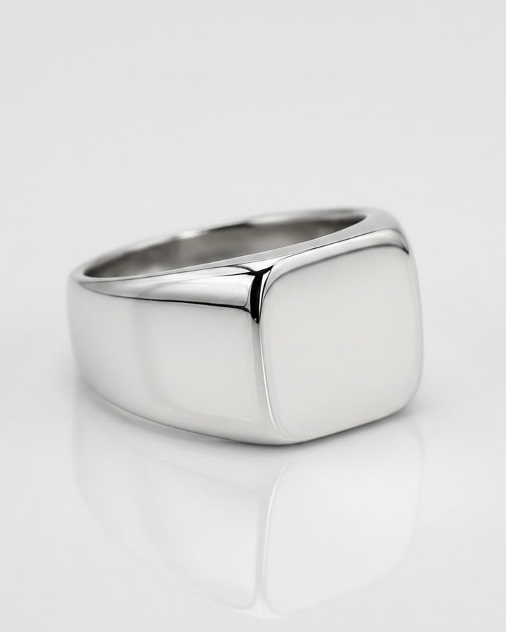 Elli Jewellery polished silver stainless steel classic signet ring with a smooth square face on a white background.