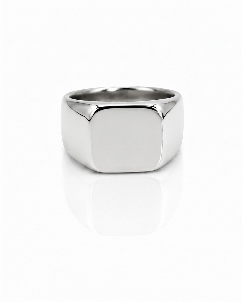 Elli Jewellery silver stainless steel classic signet ring with a polished finish on a white reflective surface.