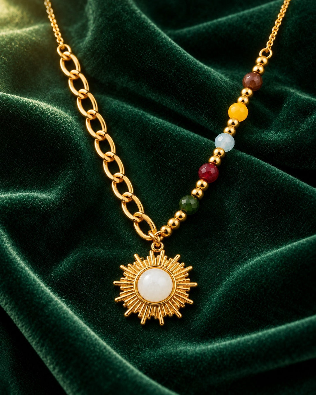 Elli Jewellery gold plated sunbeam pendant necklace with multicolour enamel beads on a green velvet background