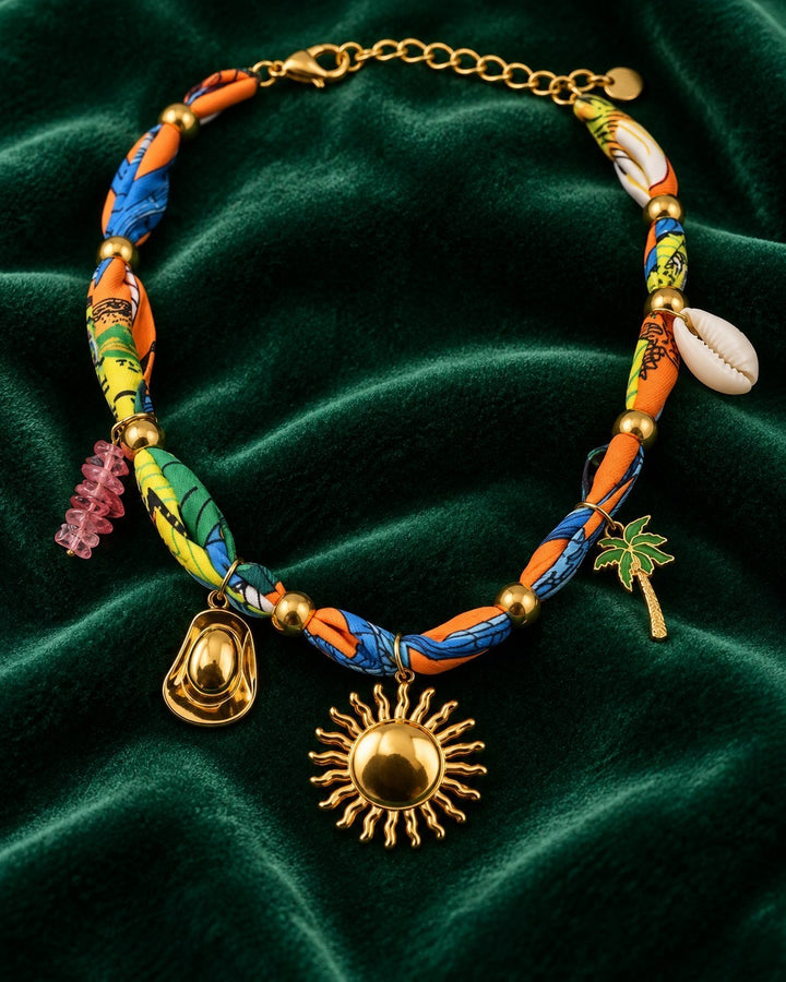 Elli Jewellery gold plated sunflower charm necklace with colourful fabric-wrapped chain, shell, and palm tree charms.