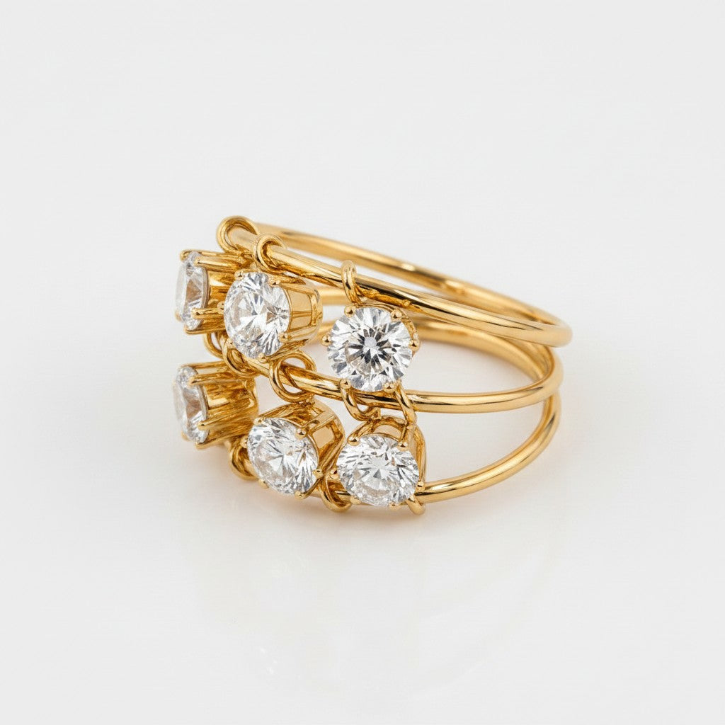 Elli Jewellery triple band statement ring in 18ct gold plated brass with six prong-set clear cubic zirconia stones.