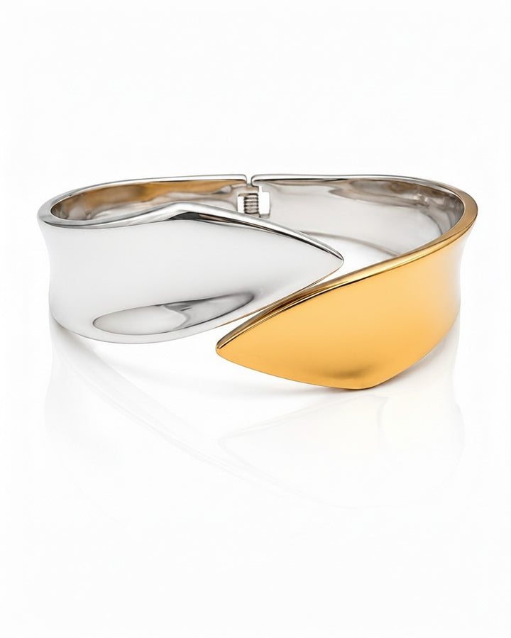 Elli Jewellery two-tone bangle bracelet featuring a sculptural fusion of polished silver and matte rose gold metal.