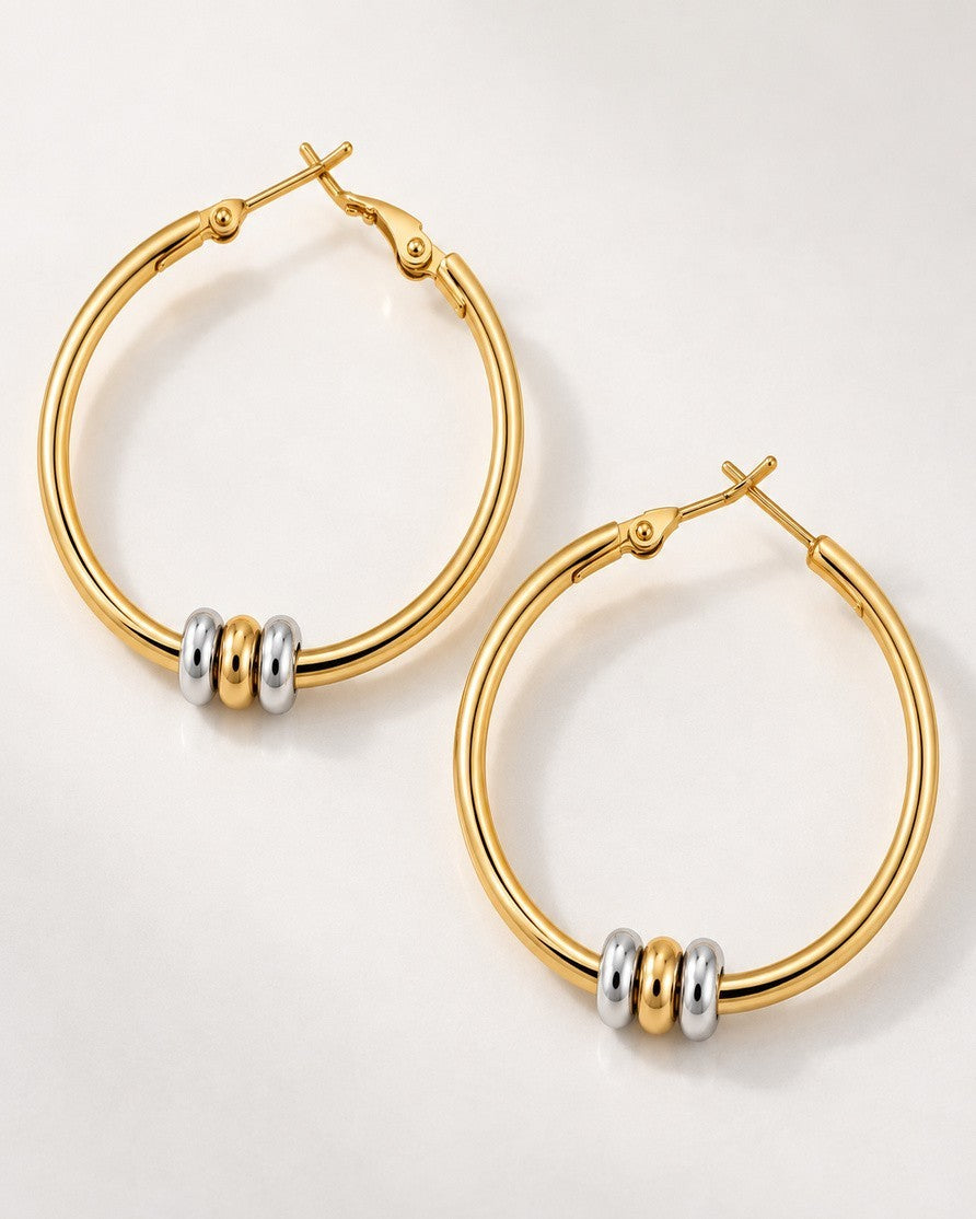 Elli Jewellery two-tone hoop earrings featuring 18ct gold plated hoops with rhodium and gold-tone accent beads.