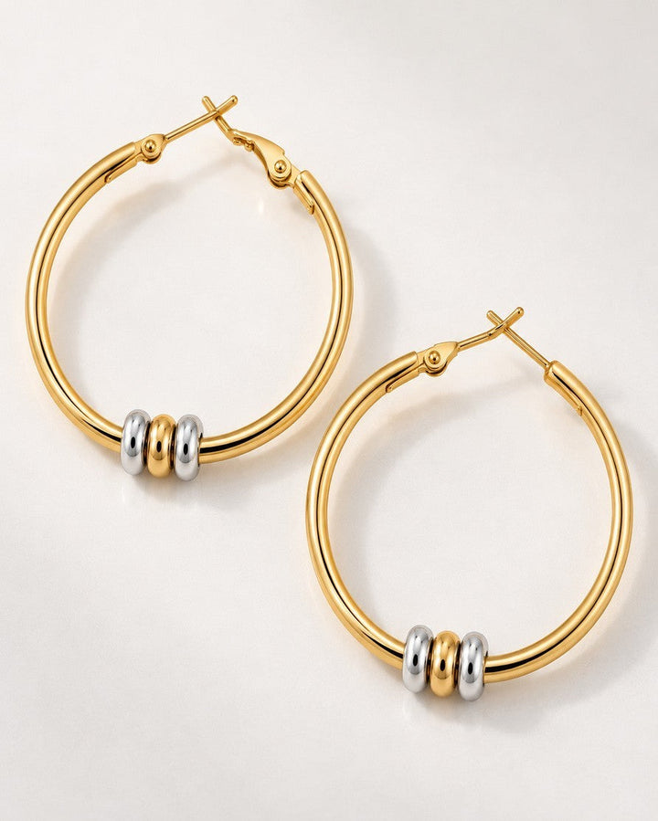 Elli Jewellery two-tone hoop earrings featuring 18ct gold plated hoops with rhodium and gold-tone accent beads.