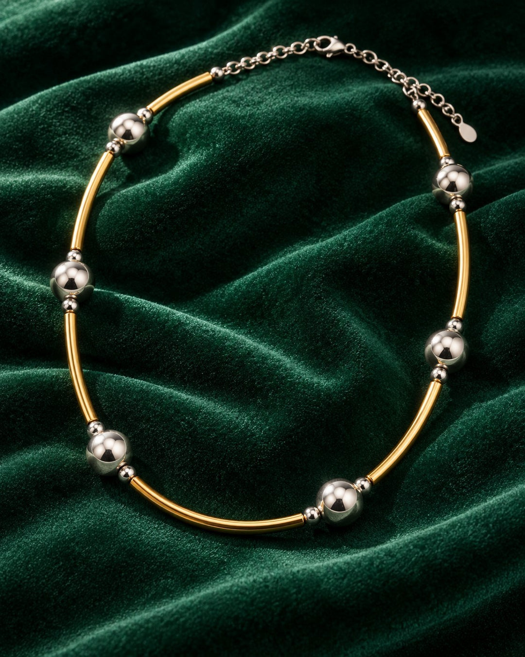 Elli Jewellery two-tone beaded statement necklace featuring alternating gold and silver-tone beads on a velvet background