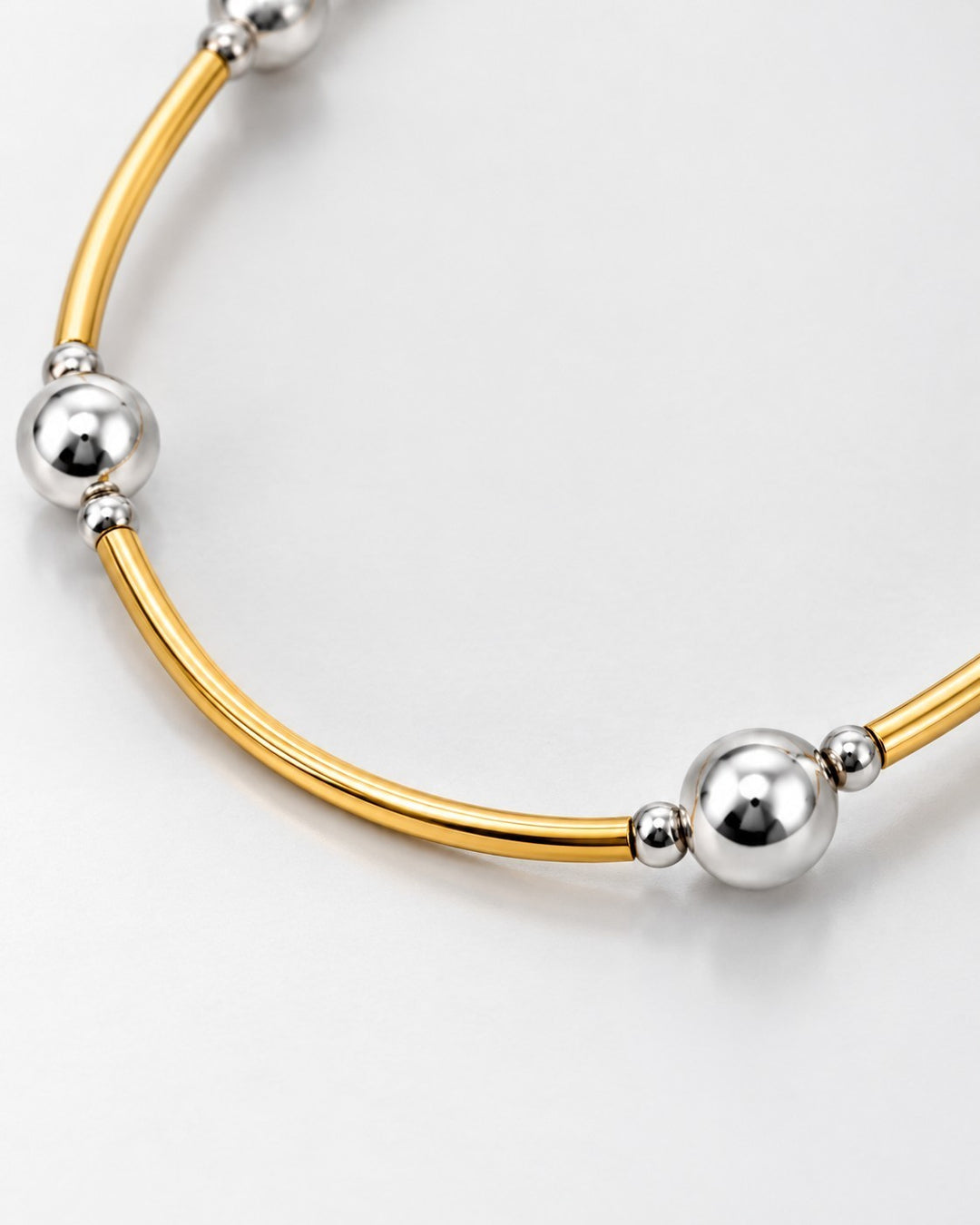 Elli Jewellery two-tone statement necklace featuring alternating gold-plated bars and polished silver-tone beads.