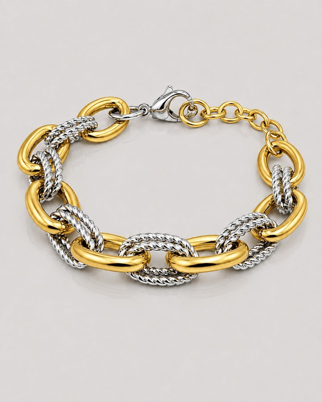 Elli Jewellery chunky two-tone link bracelet featuring alternating smooth gold-plated and textured silver-tone links.