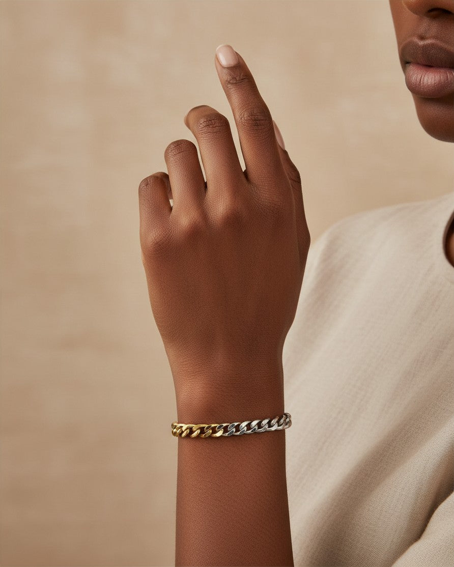 Elli Jewellery two-tone Cuban link chain bracelet in gold and silver worn on a woman's wrist