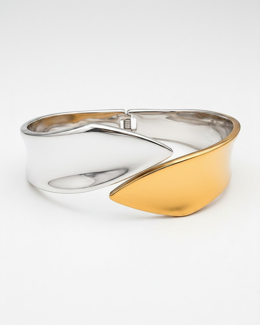 Elli Jewellery two-tone bangle bracelet featuring a sculptural fusion of polished silver and matte gold-plated metal.