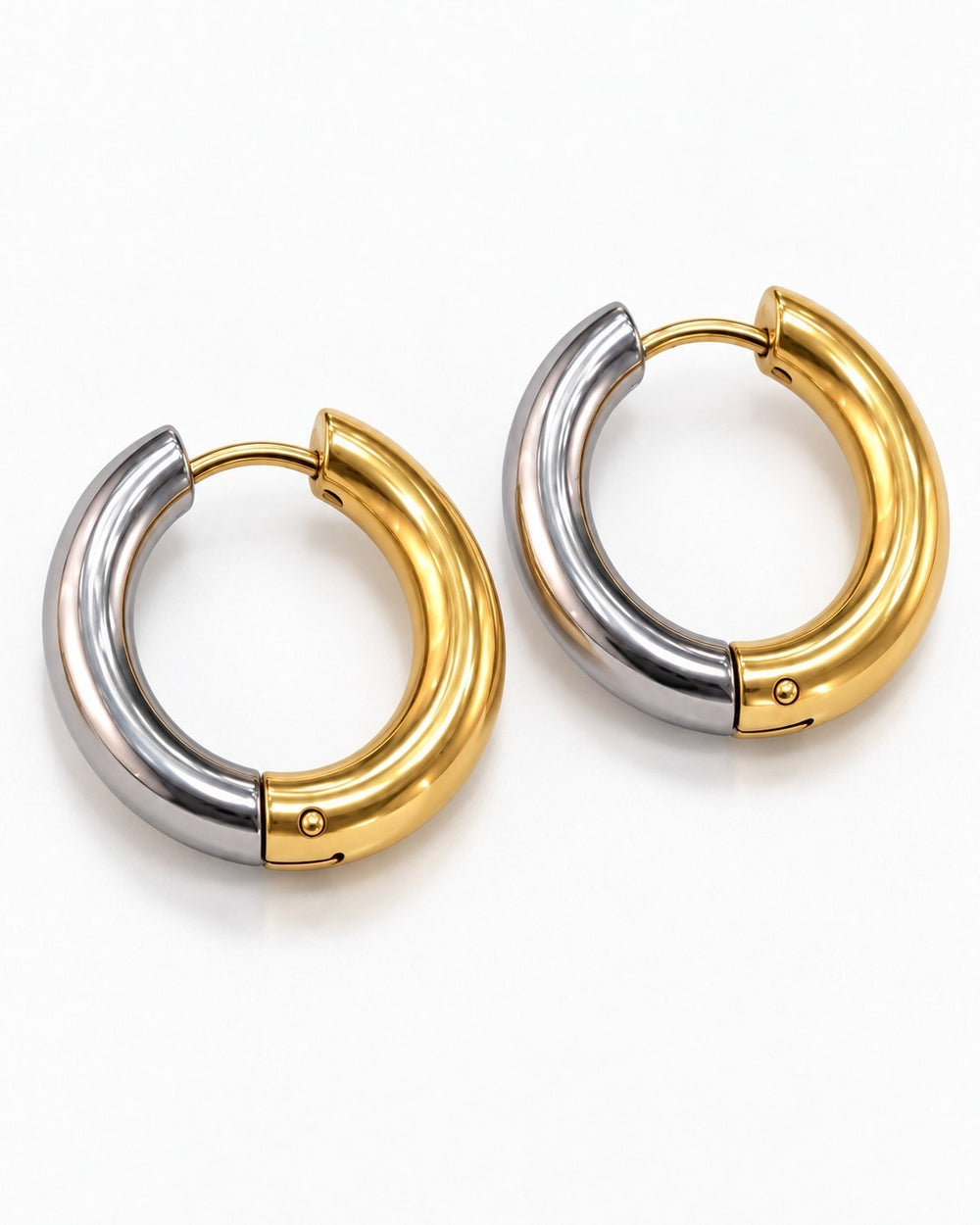 Elli Jewellery two-tone 22mm huggie hoop earrings in gold and silver plating with a chunky, polished finish.