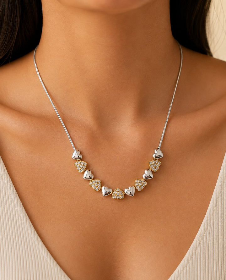 Elli Jewellery two-tone heart charm necklace with rhodium plated silver and crystal-set gold plated heart accents.