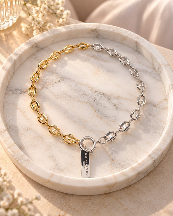 Elli Jewellery two-tone gold and silver plated oval link chain necklace with a toggle clasp on a marble tray.