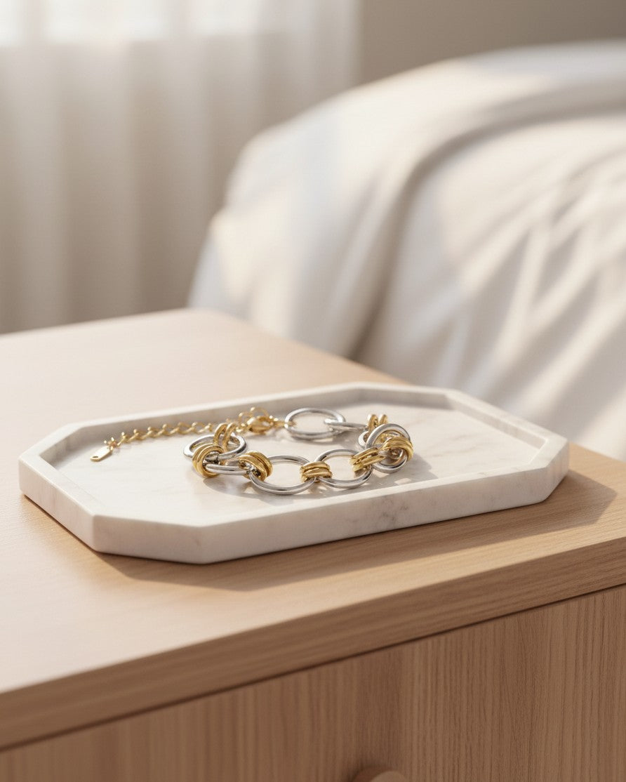 Elli Jewellery two-tone ribbed link bracelet in gold and silver finish resting on a white marble tray.