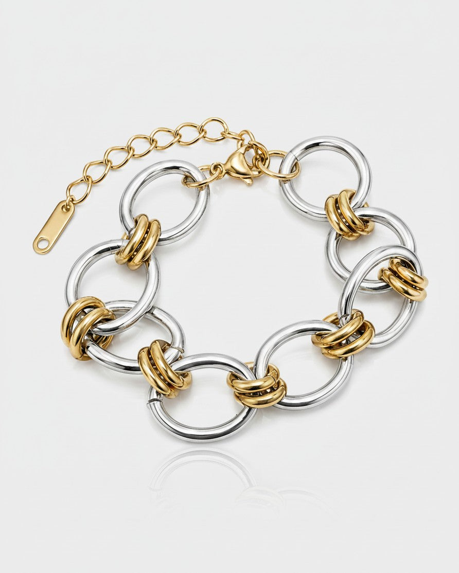 Elli Jewellery two-tone statement bracelet featuring chunky gold and silver plated ribbed links on a white background.