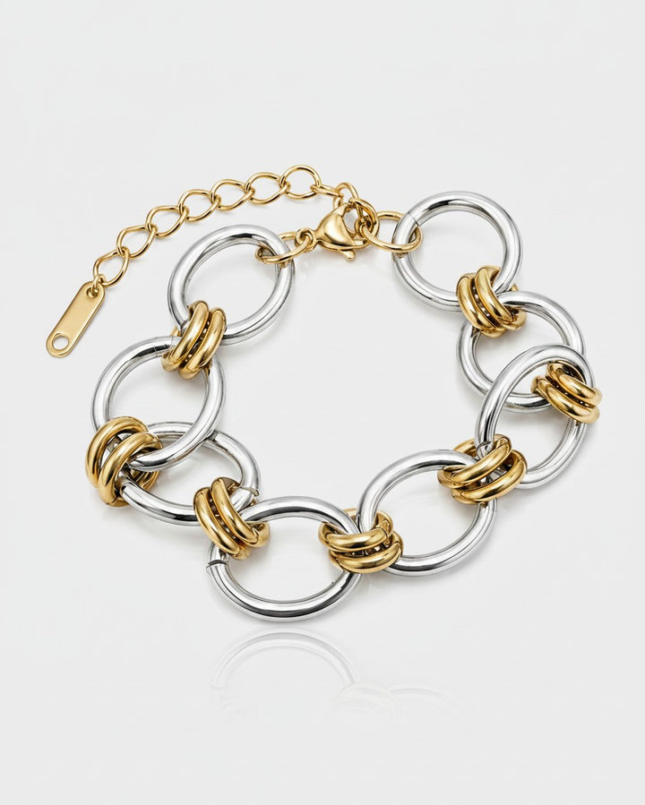 Elli Jewellery two-tone statement bracelet featuring chunky gold and silver plated ribbed links on a white background.