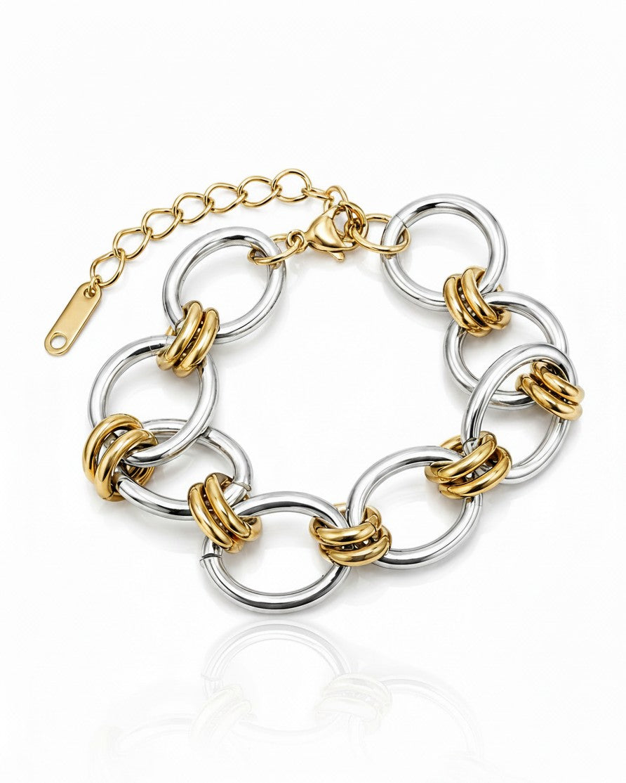 Elli Jewellery two-tone ribbed link statement bracelet in gold and silver plated metal on a white background.
