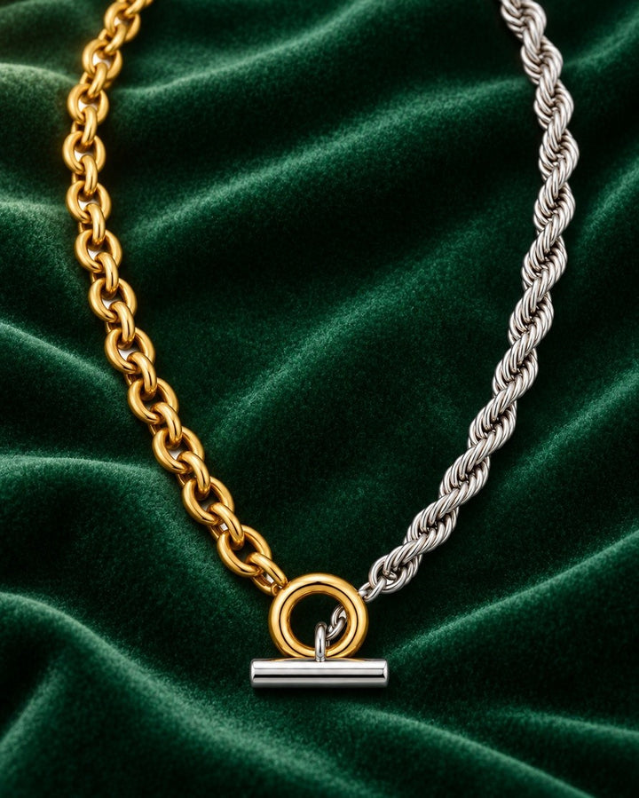 Elli Jewellery two-tone chunky rope chain necklace with gold and silver links and a toggle clasp on green velvet.