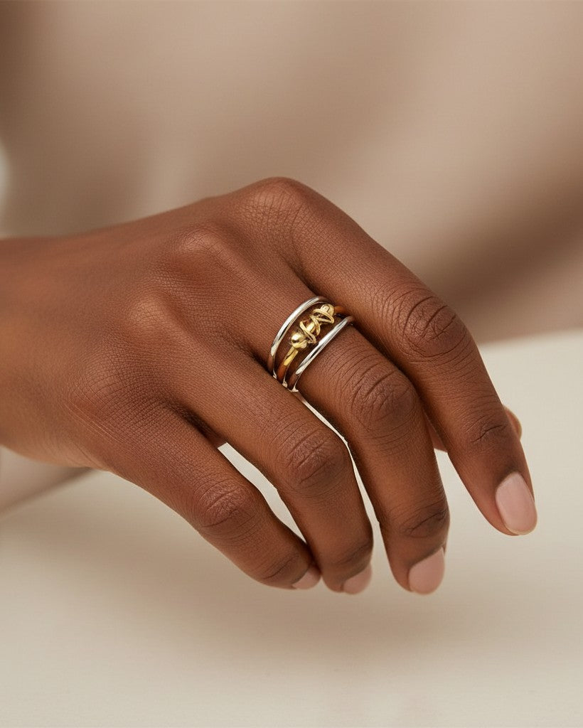 Elli Jewellery gold plated two-tone triple band stacked ring set worn on a hand