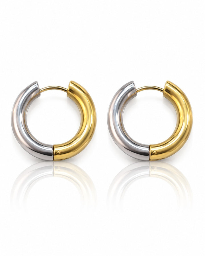 Elli Jewellery two-toned 24mm chunky huggie hoop earrings featuring a polished gold and silver plated finish.
