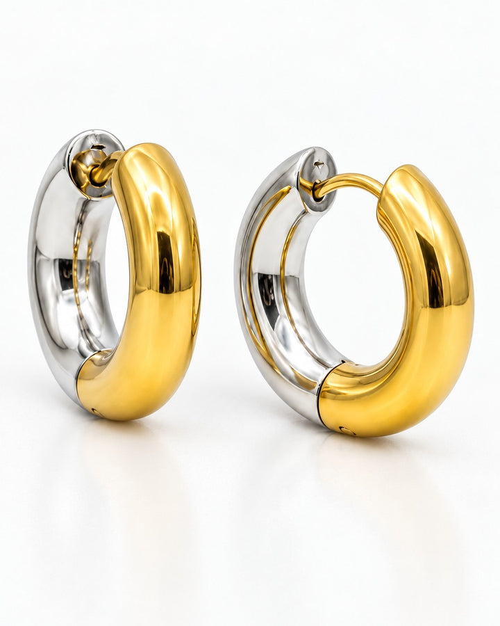 Elli Jewellery two-toned 24mm chunky huggie hoop earrings featuring a polished gold and silver plated finish.