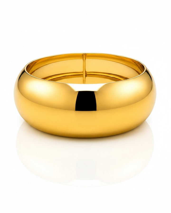 Elli Jewellery wide gold plated statement bangle with a smooth polished finish and waterproof design.