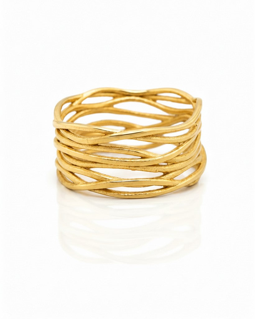 Elli Jewellery wide gold plated band ring featuring an intricate woven reed texture pattern on a white background.